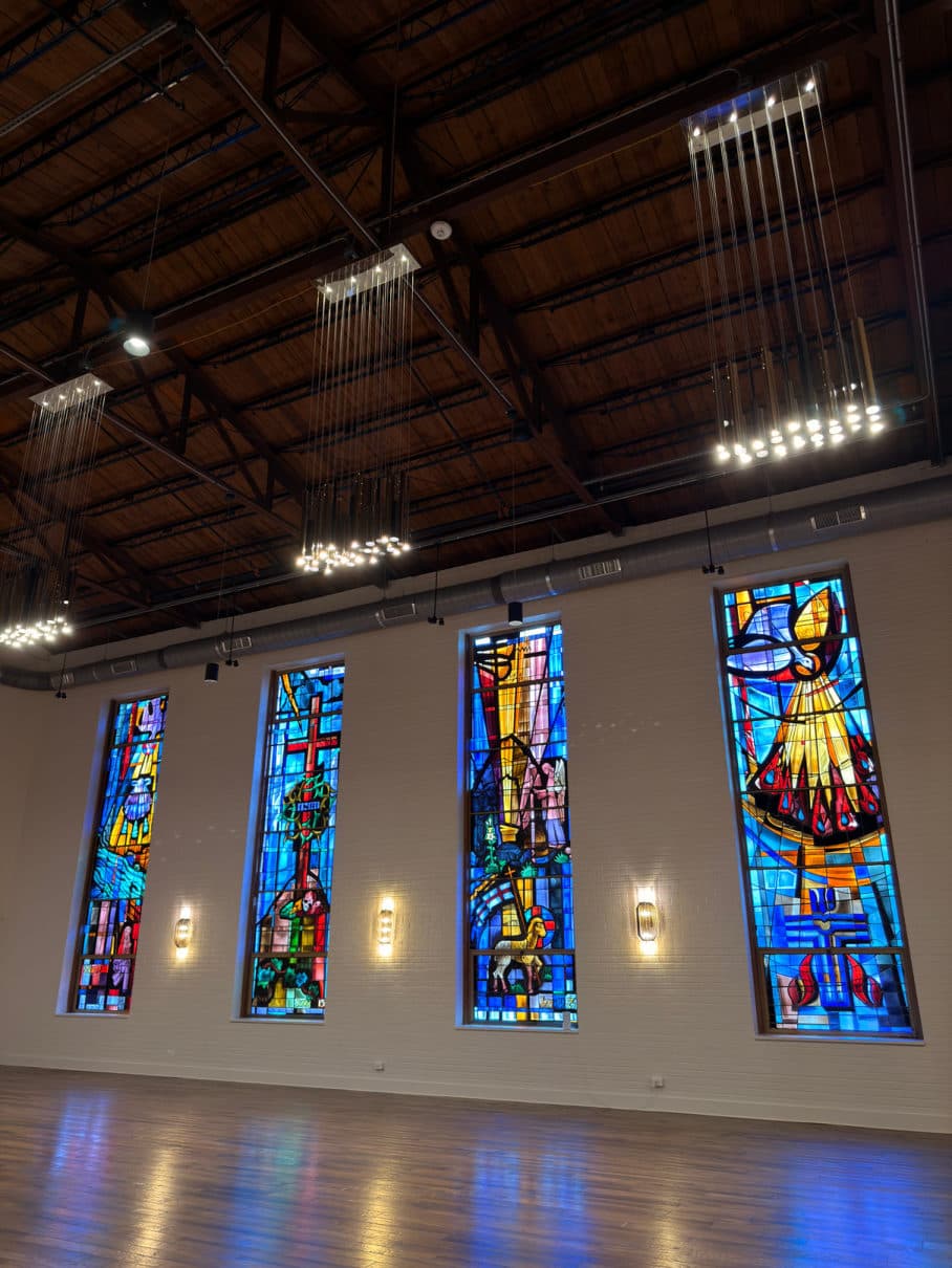 A guest standing before the stained glass windows at Chatelet