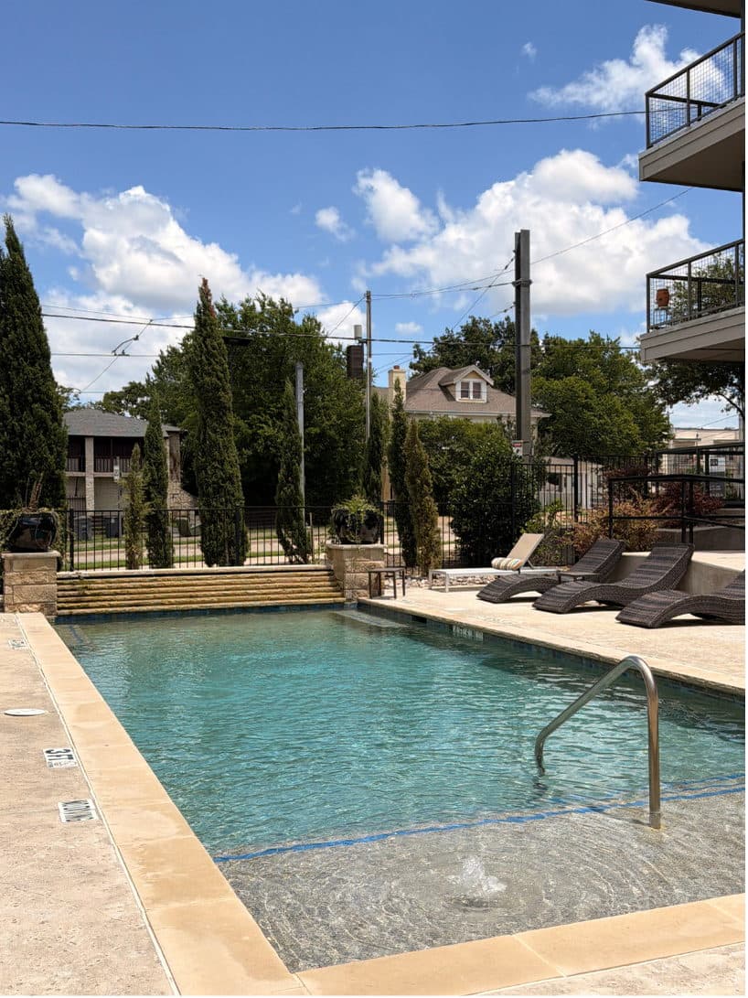 Pool deck framed by cypress trees